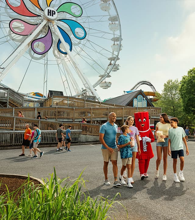 family walking with twizzlers character hersheypark ferris wheel in background