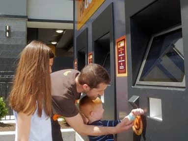 boy scanning wristband at hpgo kiosk